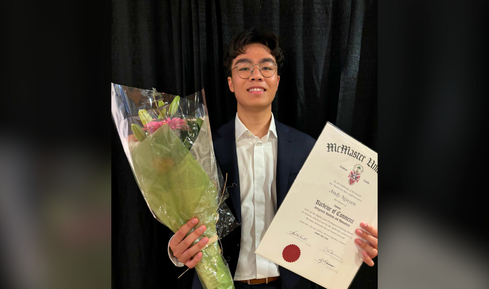 Andy Nguyen holding a bouquet of flowers and a McMaster University degree