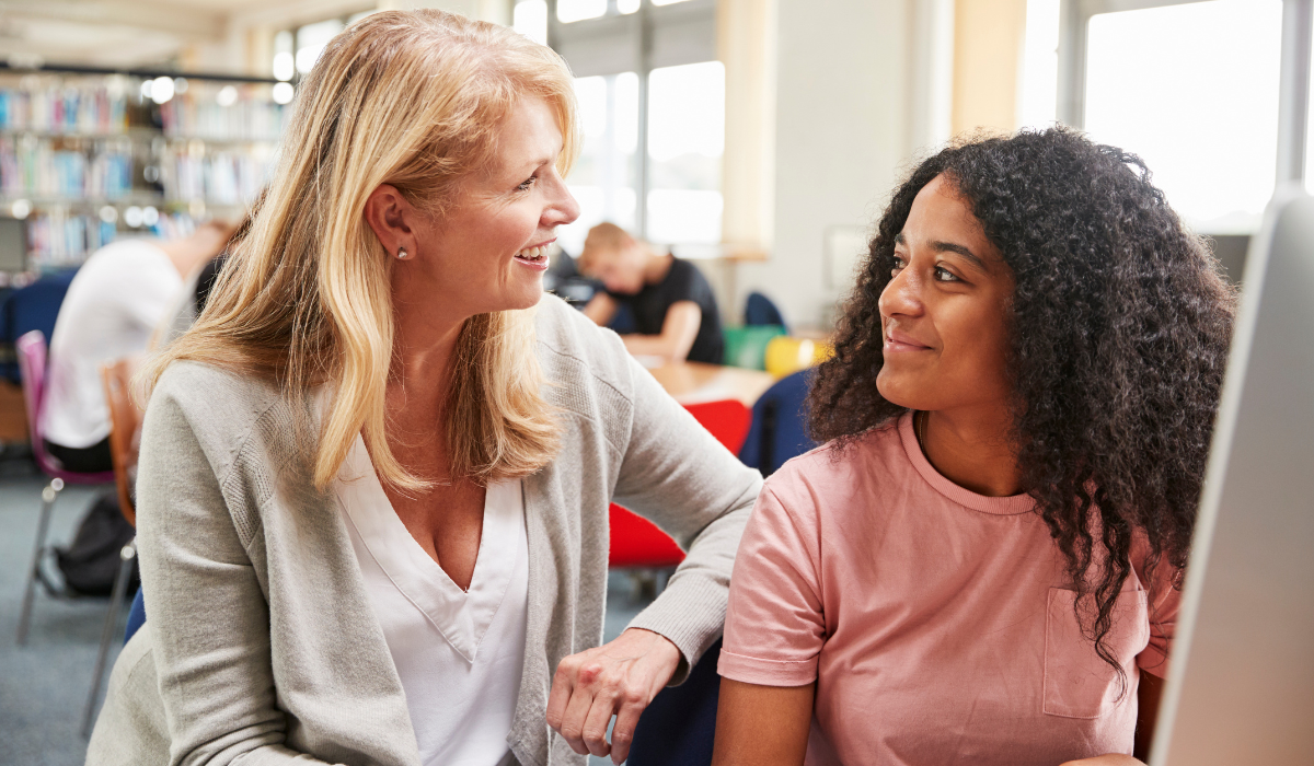 teacher helping student