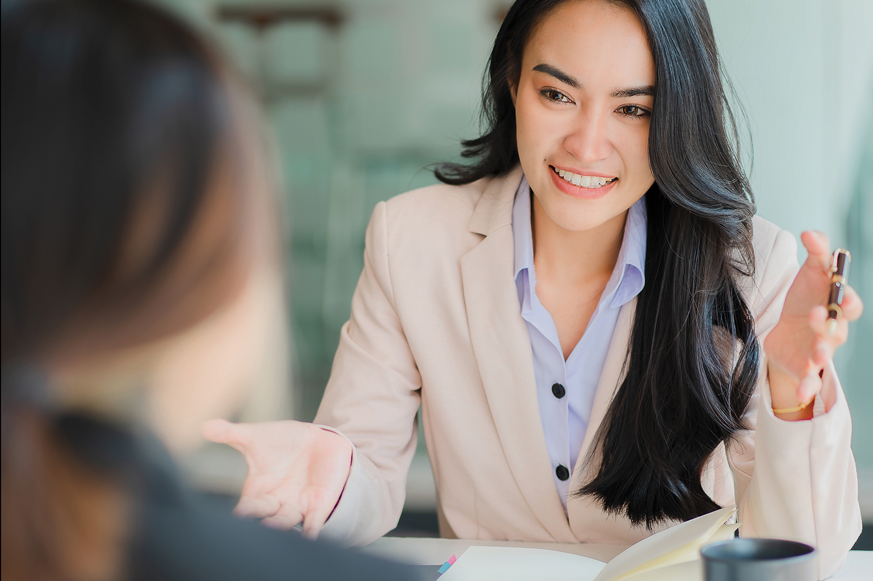 A human resource professional sits at a table with another individual